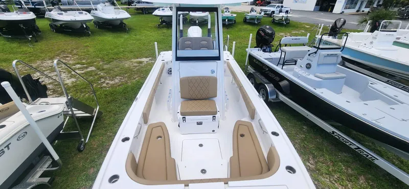 Slide: The Image of 2025 Blazer Bay 2440 boat on display at a dealership. - 6
