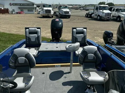Slide: The Image of 2024 Nitro ZV19 Sport boat with seating and motor in a dealership lot. - 10