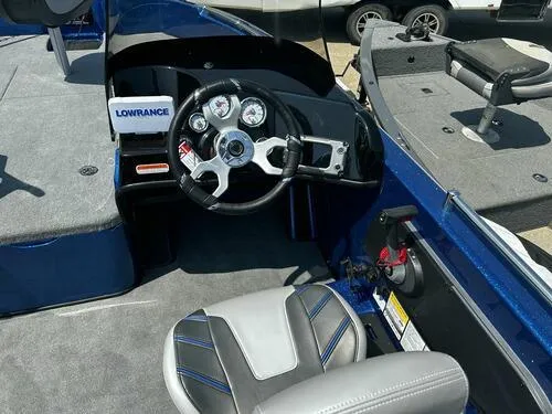 Slide: The Image of 2024 Nitro ZV19 Sport boat cockpit with steering wheel and Lowrance electronics. - 11