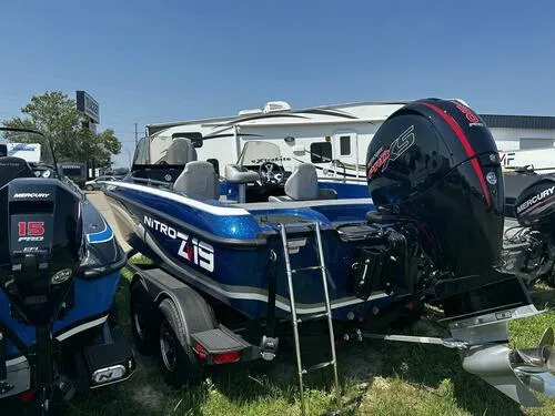 Slide: The Image of 2024 Nitro ZV19 Sport boat with Mercury engine, parked outdoors. - 4