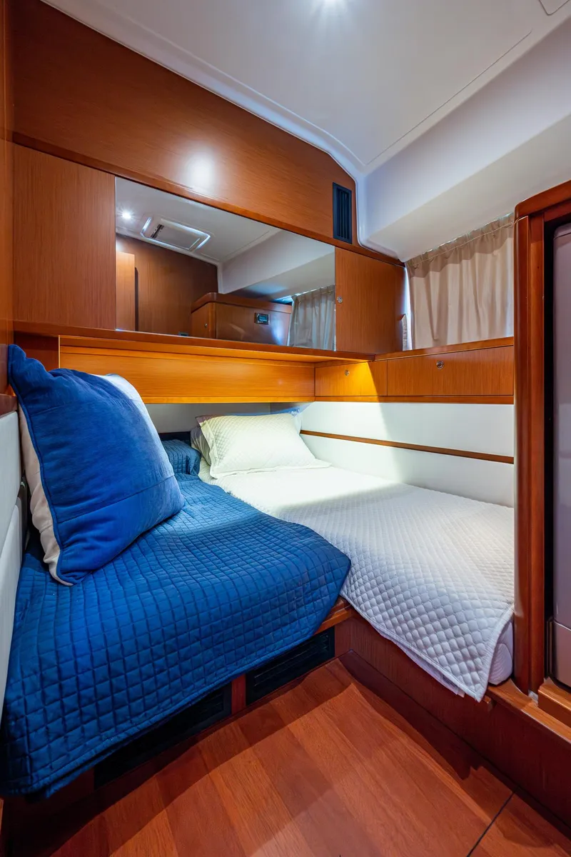 Slide: The Image of Beneteau Swift Trawler 44 2018 interior cabin with bed and washing machine. - 33