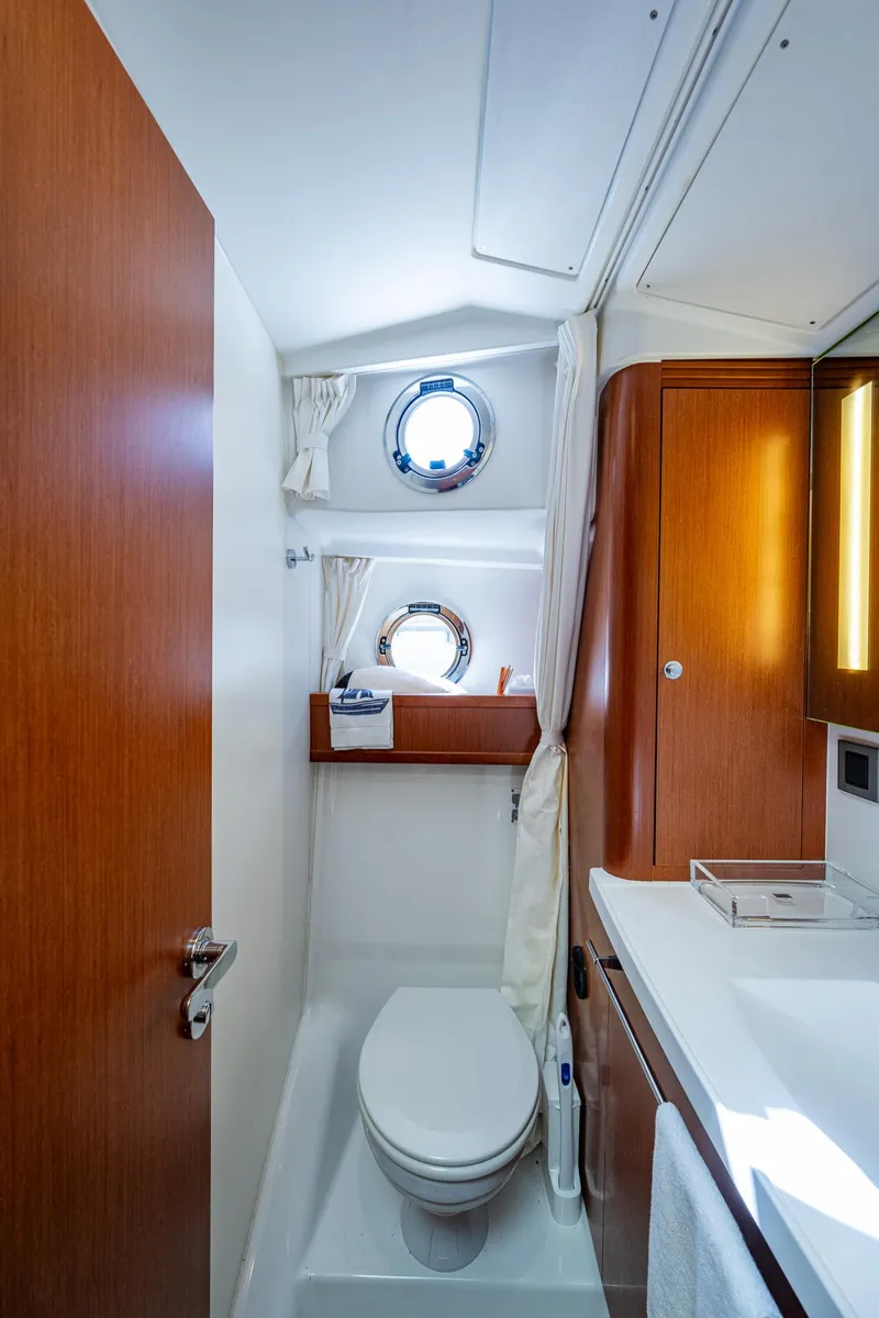 Slide: The Image of Modern bathroom in 2018 Beneteau Swift Trawler 44 with wood cabinetry and white sink. - 35