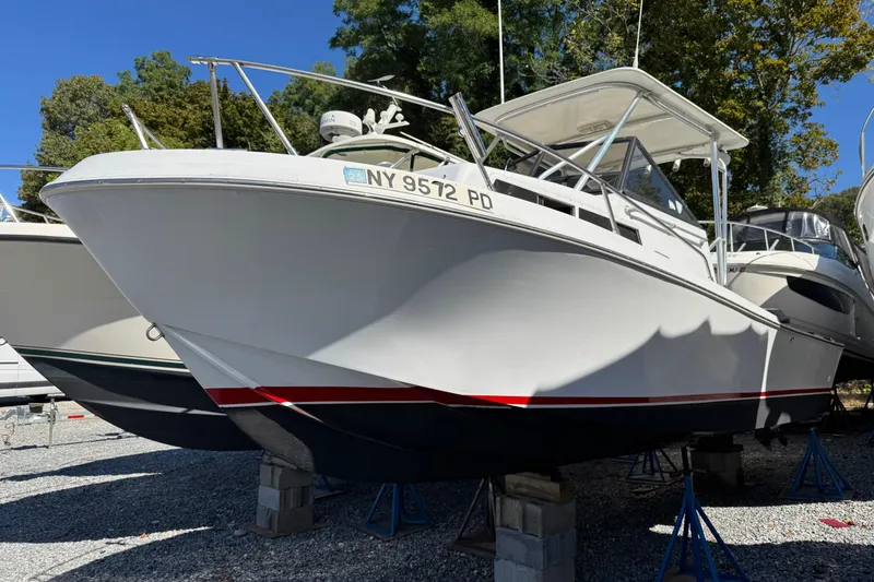The Image of 1981 Mako 233 Walk Around boat on stands, outdoors, with trees in background. - 0