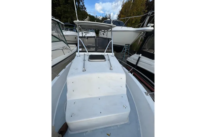 Slide: The Image of 1981 Mako 233 Walk Around boat docked among other vessels. - 17