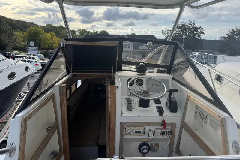 Slide: The Image of 1981 Mako 233 Walk Around boat cockpit with steering wheel and controls. - 3