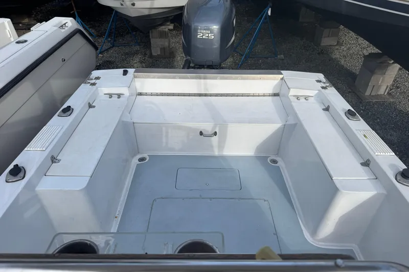 Slide: The Image of 1981 Mako 233 Walk Around boat interior with Yamaha 225 engine. - 6