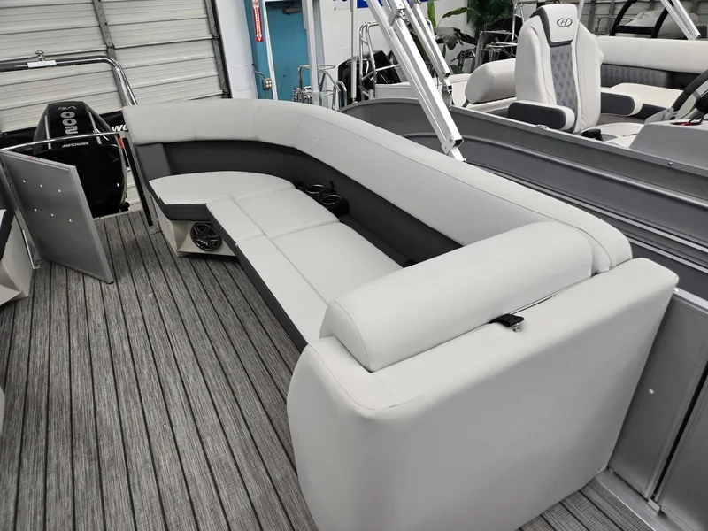 Slide: The Image of 2024 Harris Cruiser 210 pontoon boat with spacious seating and modern interior design. - 10