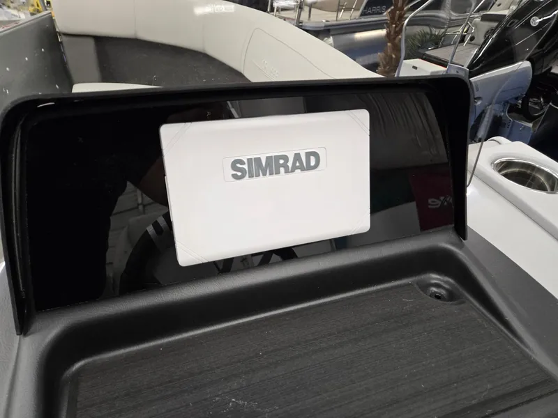 Slide: The Image of 2024 Harris Cruiser 210 boat dashboard with Simrad navigation system. - 13