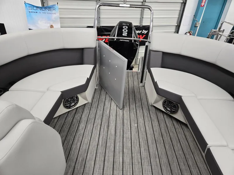 Slide: The Image of 2024 Harris Cruiser 210 boat interior with gray seating and flooring. - 17