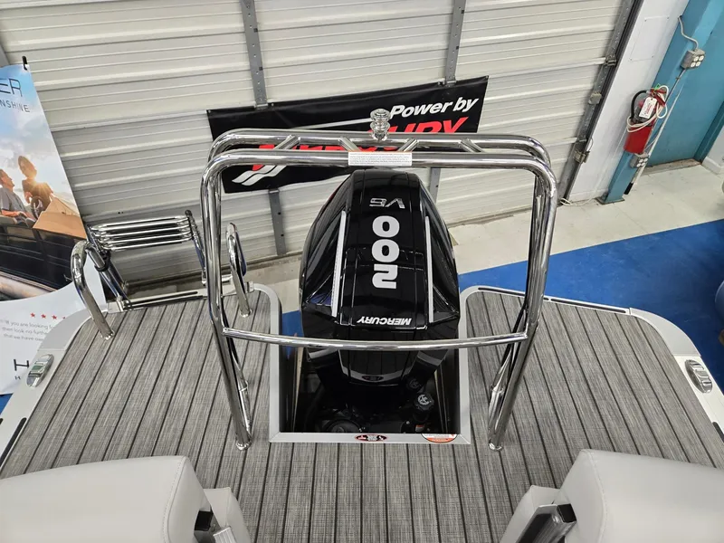 Slide: The Image of 2024 Harris Cruiser 210 with Mercury 200 HP outboard motor in showroom. - 21