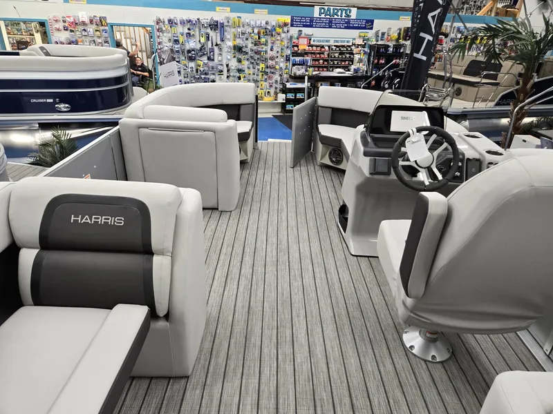Slide: The Image of 2024 Harris Cruiser 210 boat interior with gray seating and steering console. - 22