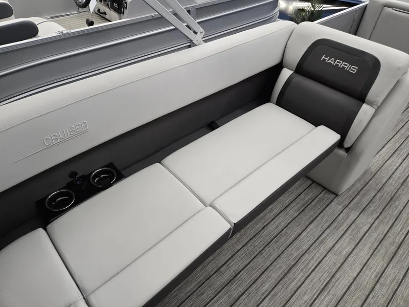 Slide: The Image of 2024 Harris Cruiser 210 boat interior with gray seating and cup holders. - 23