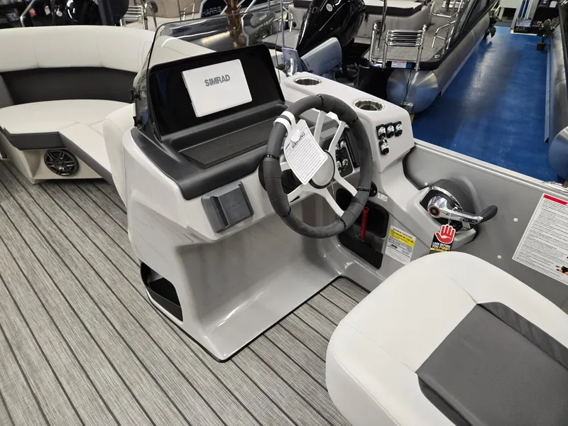 Slide: The Image of 2024 Harris Cruiser 210 boat interior with steering console and seating. - 27