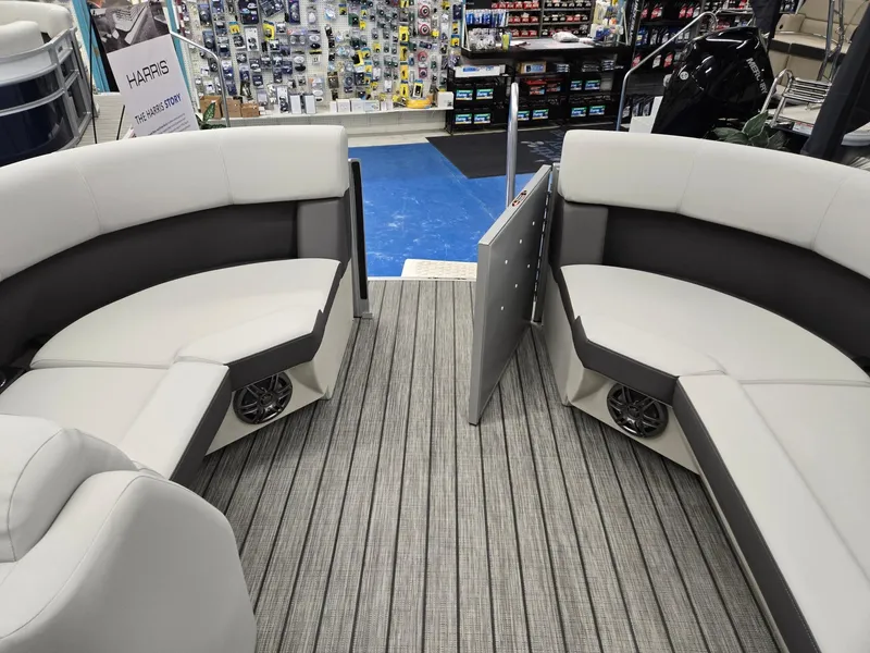 Slide: The Image of 2024 Harris Cruiser 210 boat interior with gray and white seating and marine speakers. - 28