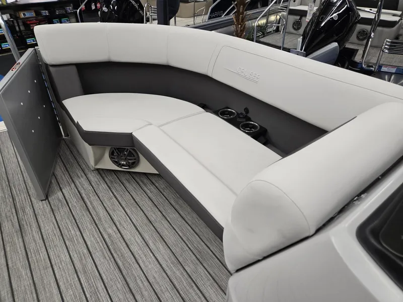 Slide: The Image of 2024 Harris Cruiser 210 boat interior with gray cushioned seating and cup holders. - 29