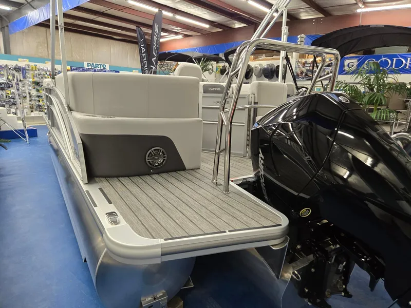 Slide: The Image of 2024 Harris Cruiser 210 pontoon boat with outboard motor in showroom. - 3