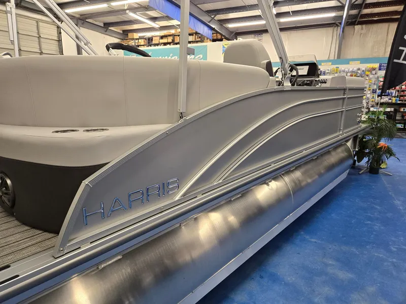 Slide: The Image of 2024 Harris Cruiser 210 pontoon boat in showroom. - 4