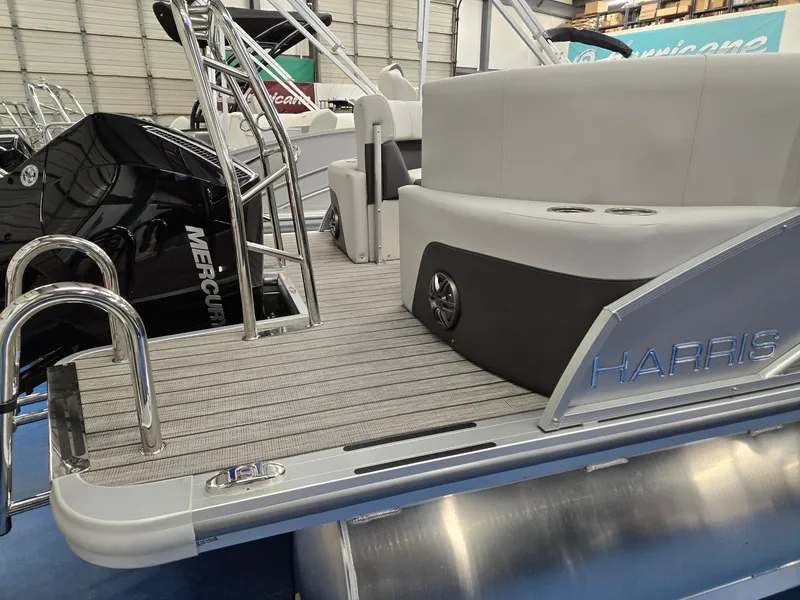 Slide: The Image of 2024 Harris Cruiser 210 pontoon boat with Mercury engine, rear deck view. - 5