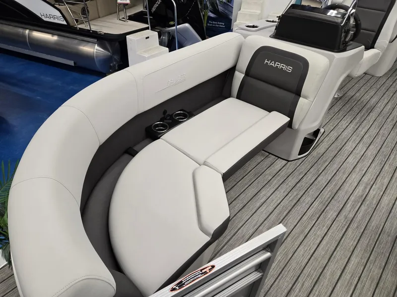 Slide: The Image of 2024 Harris Cruiser 210 boat interior with gray seating and cup holders. - 7