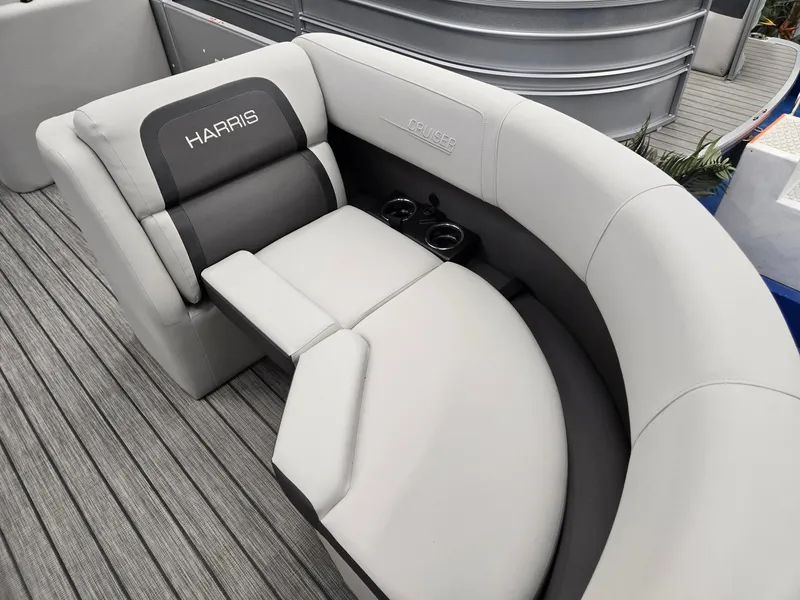 Slide: The Image of 2024 Harris Cruiser 210 boat interior with gray and white cushioned seating. - 8