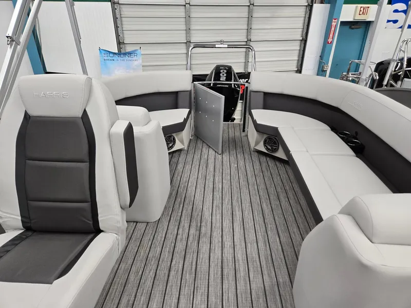 Slide: The Image of 2024 Harris Cruiser 210 boat interior with gray seating and striped flooring. - 9
