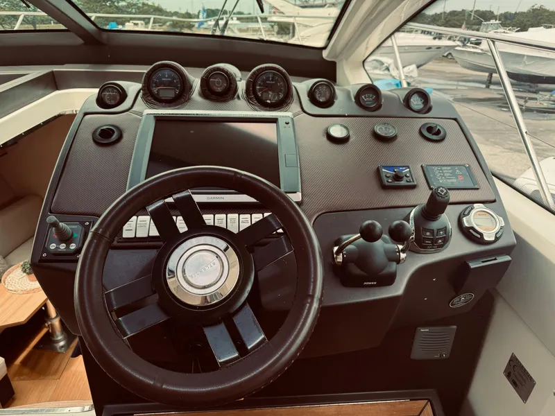 Slide: The Image of Control panel of a 2009 Azimut Atlantis 50 yacht with steering wheel and navigation instruments. - 17
