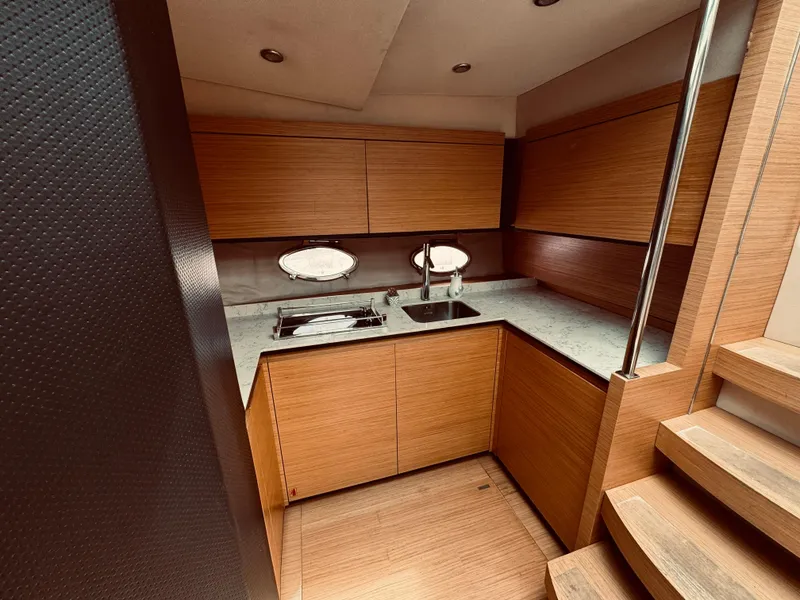 Slide: The Image of 2009 Azimut Atlantis 50 yacht kitchen with wooden cabinets and modern appliances. - 20