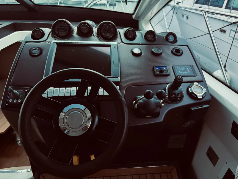 Slide: The Image of Cockpit of 2009 Azimut Atlantis 50 yacht with steering wheel and control panel. - 32