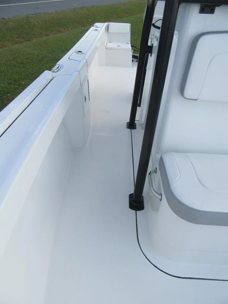 Slide: The Image of 2025 Parker 23 SE CC boat interior, featuring sleek white seating and deck design. - 10