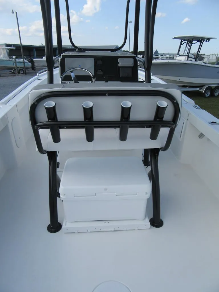Slide: The Image of 2025 Parker 23 SE CC boat interior with rod holders and cooler. - 17