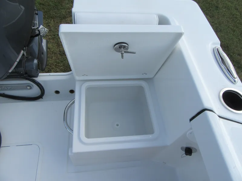 Slide: The Image of Open storage compartment on 2025 Parker 23 SE CC boat, featuring a white interior. - 19
