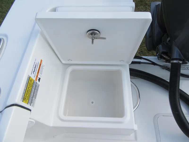 Slide: The Image of Open storage compartment on 2025 Parker 23 SE CC boat, featuring a secure latch. - 20