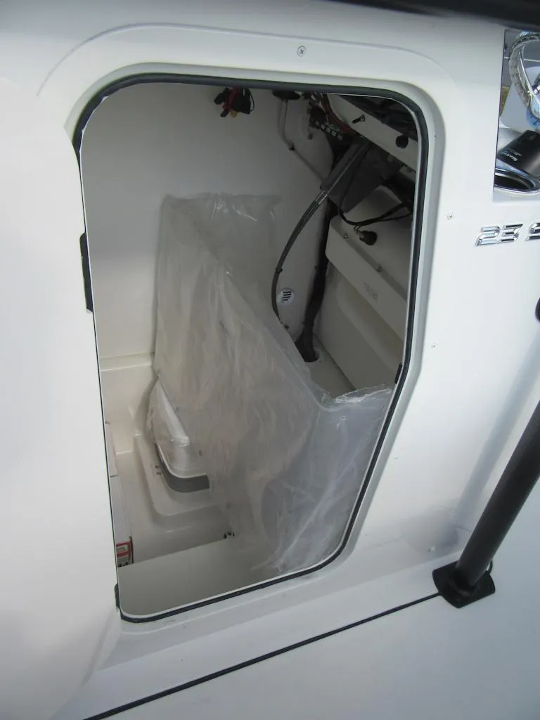 Slide: The Image of Interior view of 2025 Parker 23 SE CC boat cabin with visible wiring. - 23