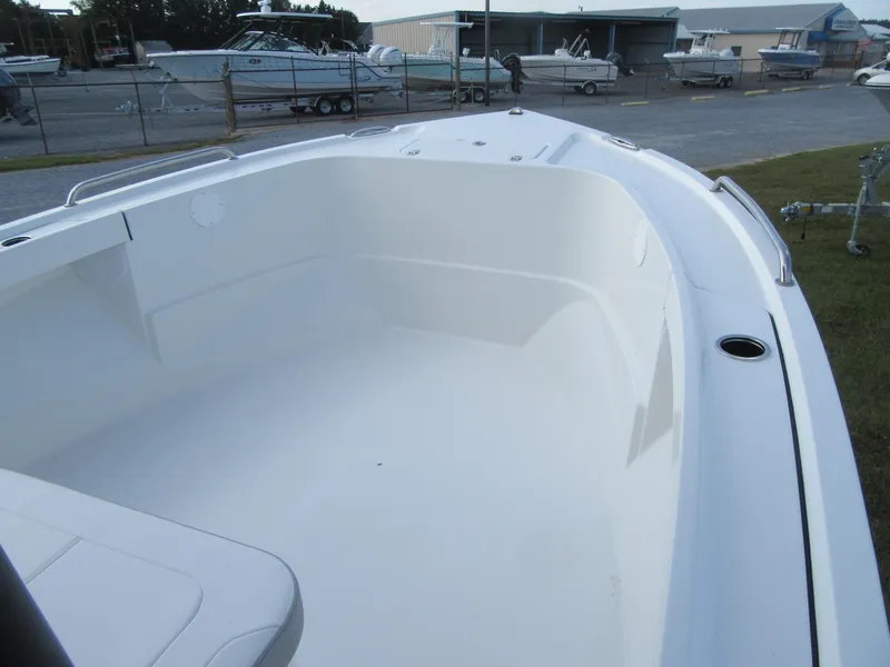 Slide: The Image of 2025 Parker 23 SE CC boat interior, showcasing spacious white deck and seating area. - 5