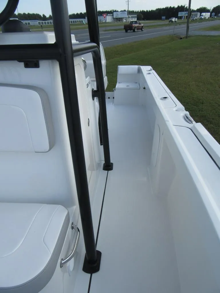 Slide: The Image of 2025 Parker 23 SE CC boat interior, white deck, black railings, roadside view. - 9