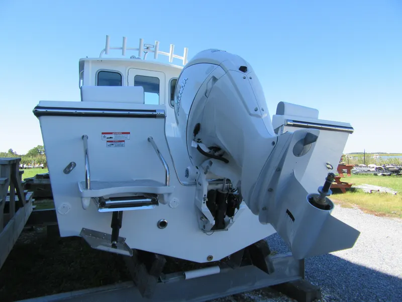 Slide: The Image of 2025 Parker 2120 Sport Cabin boat rear view with outboard motor. - 3