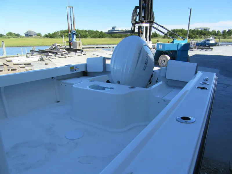 Slide: The Image of 2025 Parker 2120 Sport Cabin boat with Yamaha outboard motor at a dockside location. - 6