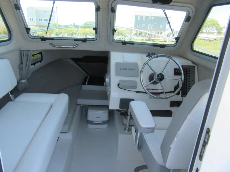 Slide: The Image of Interior of 2025 Parker 2120 Sport Cabin with steering wheel and Garmin navigation system. - 7