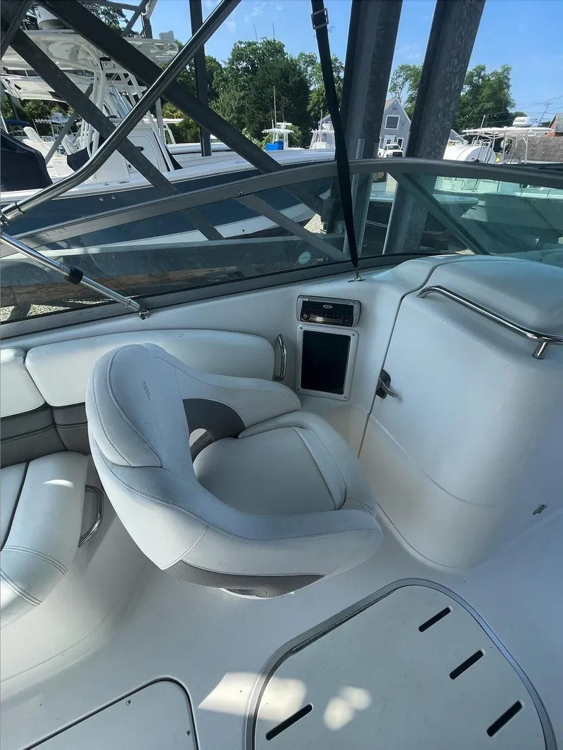 Slide: The Image of 2004 Four Winns 250 Horizon boat interior with white seating and dashboard. - 12