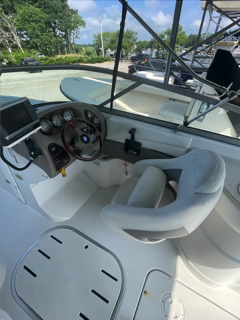 Slide: The Image of 2004 Four Winns 250 Horizon boat cockpit with steering wheel and control panel. - 13