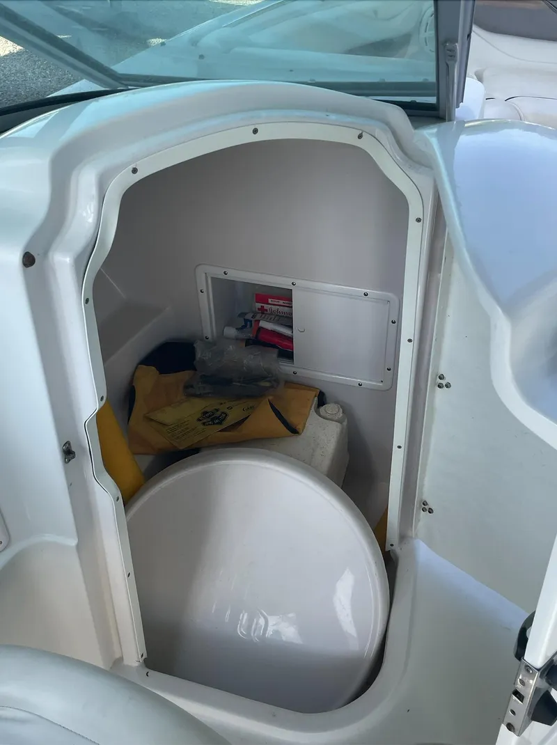 Slide: The Image of 2004 Four Winns 250 Horizon boat storage compartment with safety equipment. - 15