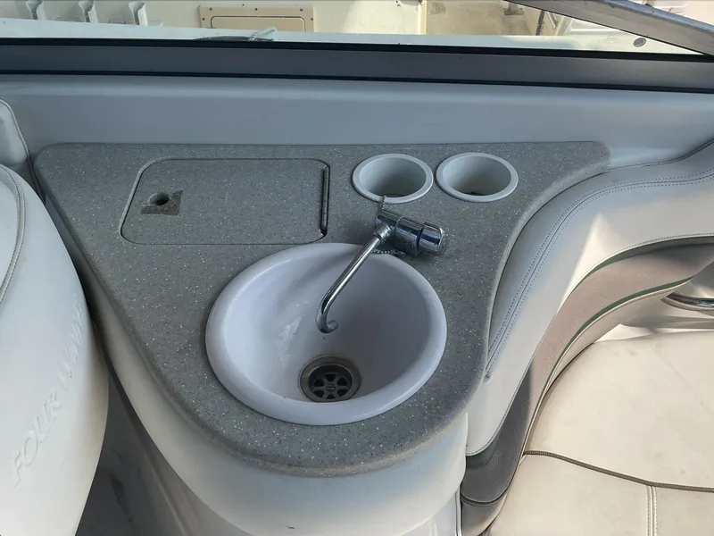 Slide: The Image of 2004 Four Winns 250 Horizon boat sink and countertop with cup holders. - 16