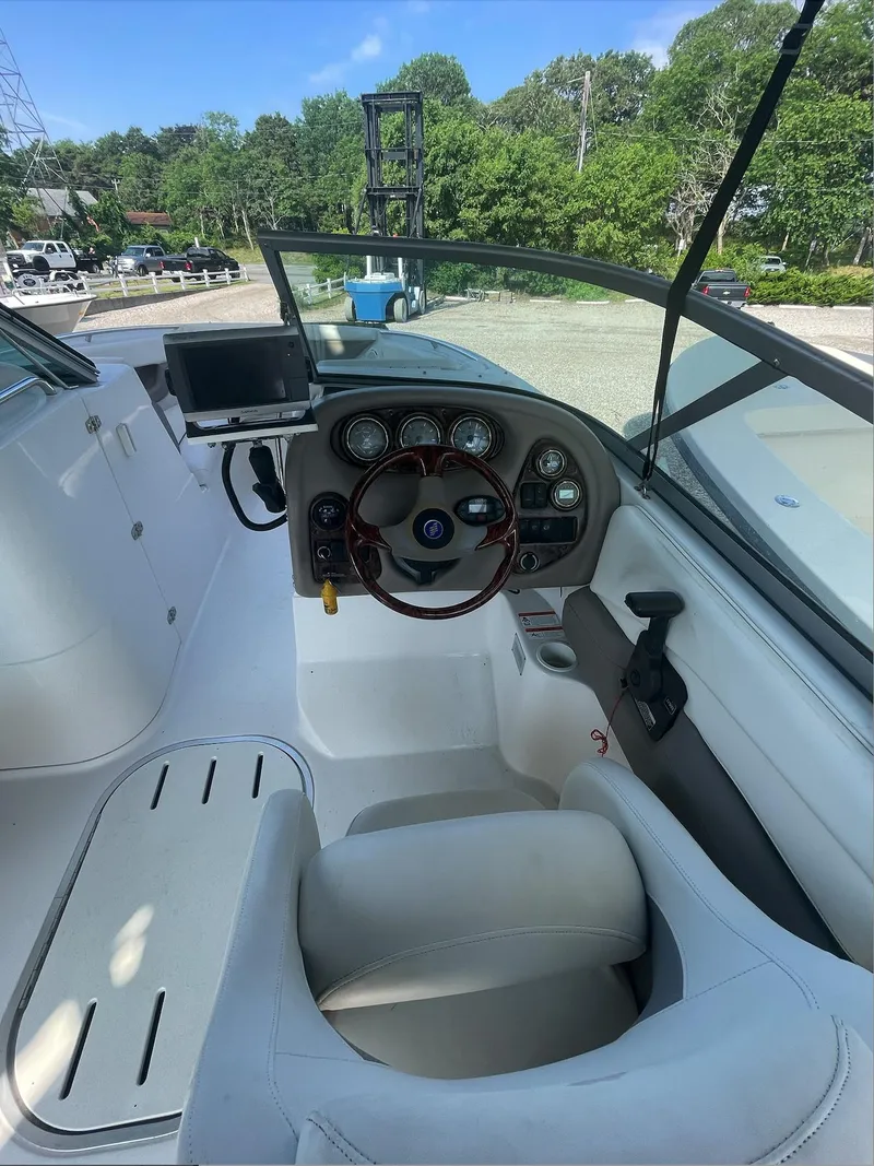 Slide: The Image of 2004 Four Winns 250 Horizon boat cockpit with steering wheel and dashboard. - 7