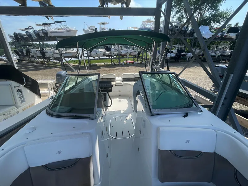 Slide: The Image of 2004 Four Winns 250 Horizon boat with green canopy in storage. - 9