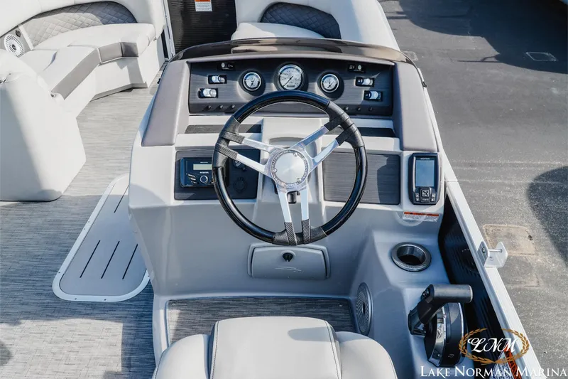Slide: The Image of 2023 Bennington 23 LSR boat dashboard with steering wheel and control panel. - 10