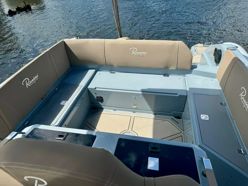 Slide: The Image of Interior of 2025 Ranieri CAYMAN 28 EXECUTIVE boat with beige seating and storage compartments. - 11