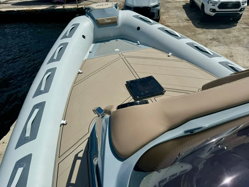 Slide: The Image of 2025 Ranieri CAYMAN 28 EXECUTIVE boat docked, showcasing spacious deck and sleek design. - 18