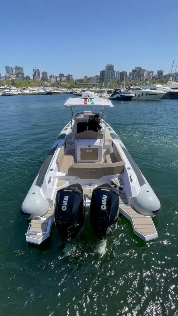 Slide: The Image of 2025 Ranieri CAYMAN 28 EXECUTIVE boat with twin outboard engines in a marina. - 5