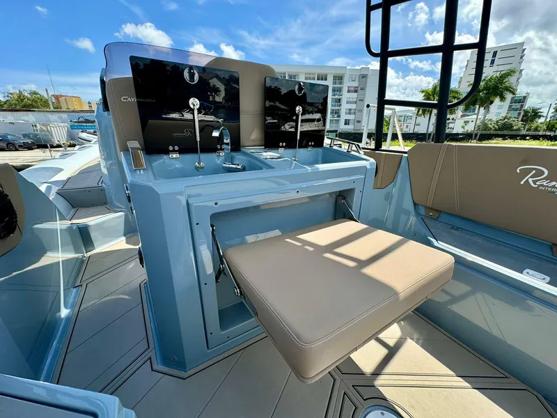 Slide: The Image of 2025 Ranieri CAYMAN 28 EXECUTIVE boat interior with modern controls and seating. - 14