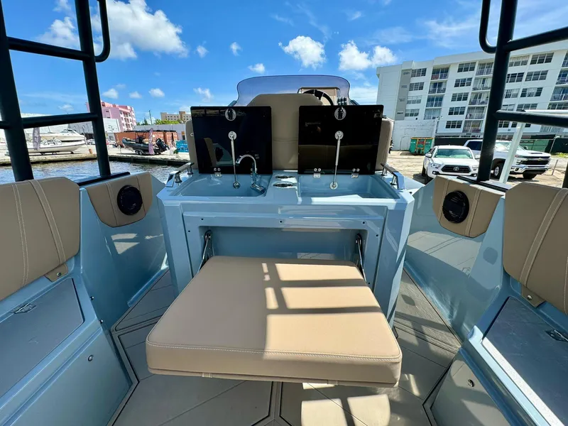 Slide: The Image of 2025 Ranieri CAYMAN 28 EXECUTIVE boat interior with beige seating and modern controls. - 16